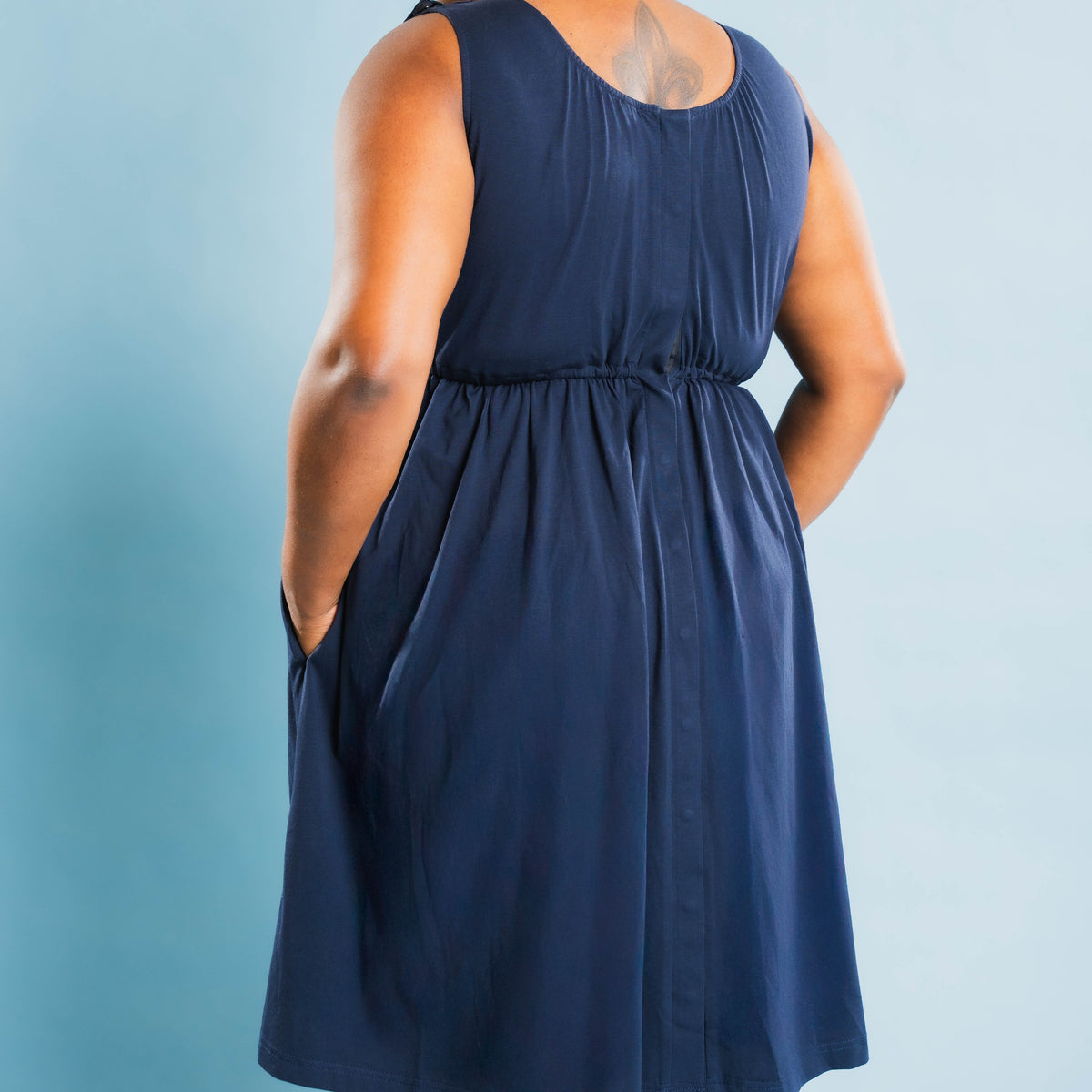 Back of the Baby Bliss Amora labor gown in navy, showing the full-length back snap placket